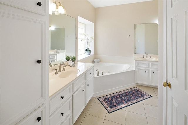 full bathroom with two vanities, a sink, a garden tub, and tile patterned floors