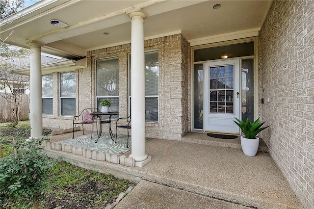 view of exterior entry featuring brick siding