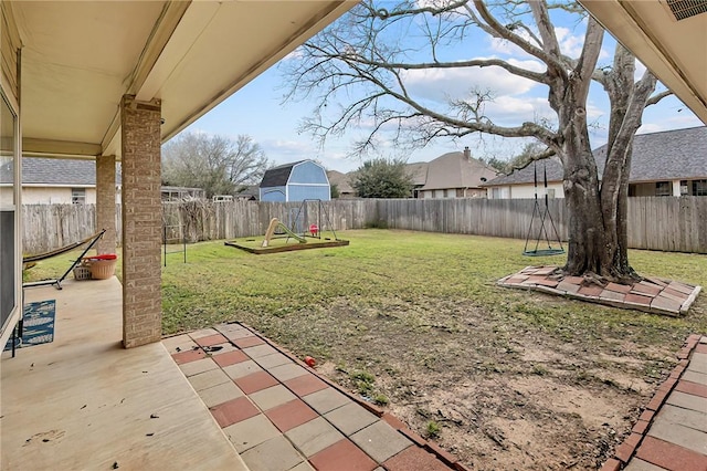 view of yard featuring a fenced backyard, a patio, and visible vents