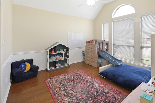 recreation room with ceiling fan, vaulted ceiling, and wood finished floors