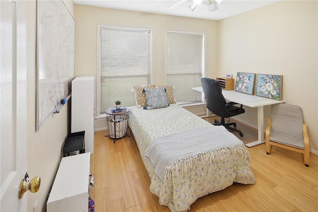 bedroom with wood finished floors and baseboards