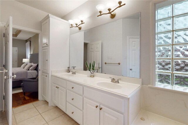 ensuite bathroom with tile patterned flooring and double vanity