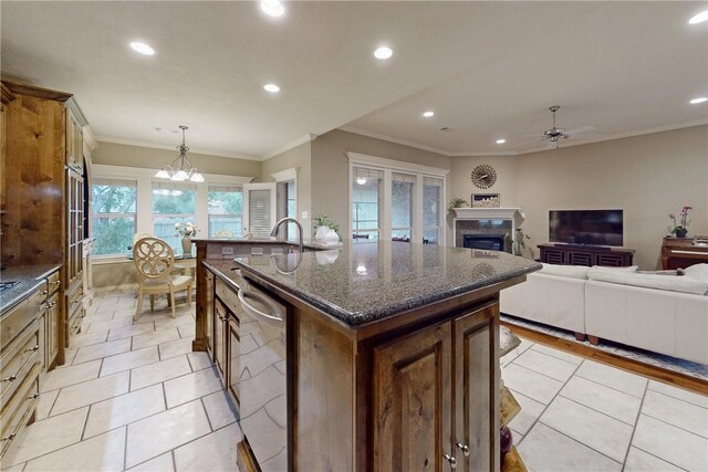 kitchen with dishwasher, a ceiling fan, a fireplace, recessed lighting, and an island with sink