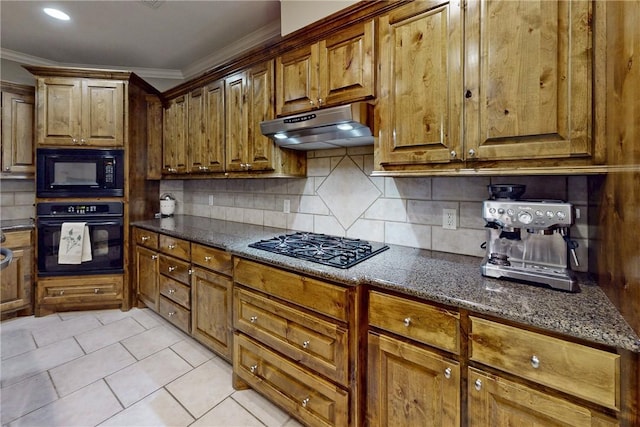 kitchen with black appliances, under cabinet range hood, crown molding, decorative backsplash, and light tile patterned floors