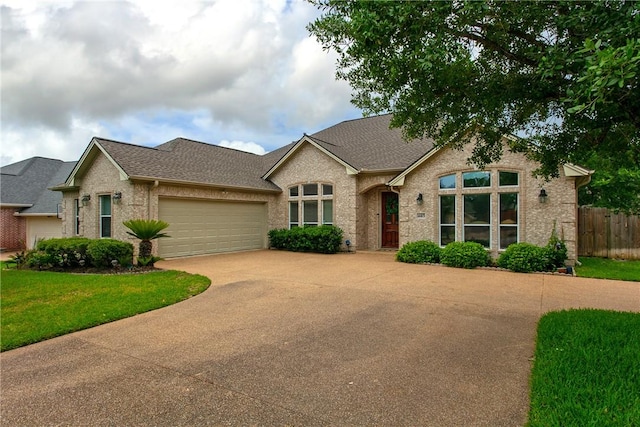 view of front facade with concrete driveway, an attached garage, roof with shingles, and brick siding