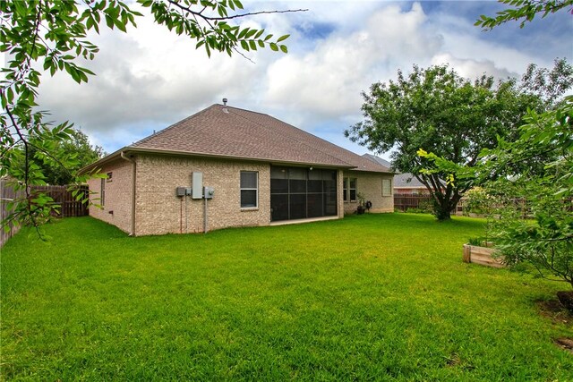 rear view of property with roof with shingles and brick siding