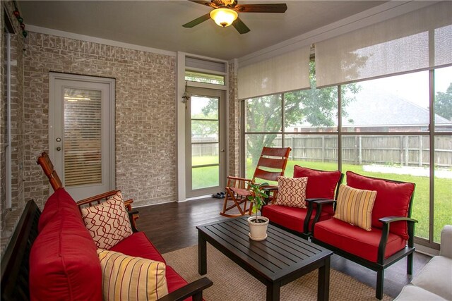 sunroom featuring outdoor lounge area and a ceiling fan