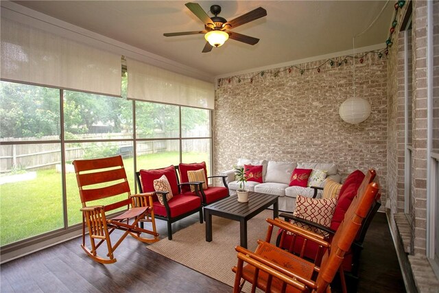 sunroom with an outdoor living space and a ceiling fan