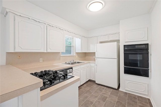 1202 Berkeley St, College Station, TX 77840 - kitchen featuring black appliances, a warming drawer, a sink, and light countertops