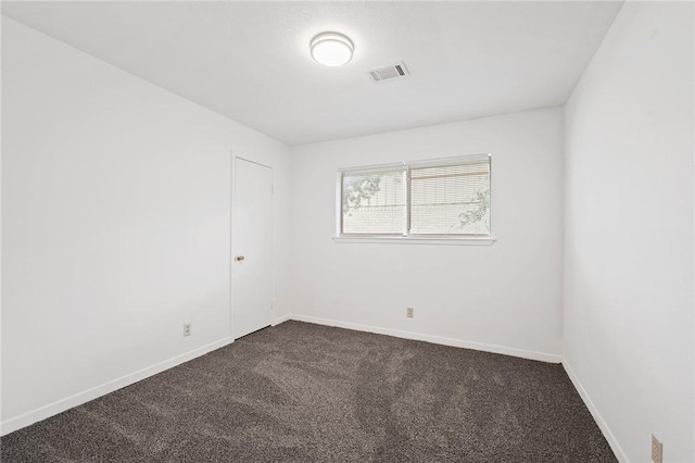 1202 Berkeley St, College Station, TX 77840 - spare room featuring dark carpet and baseboards