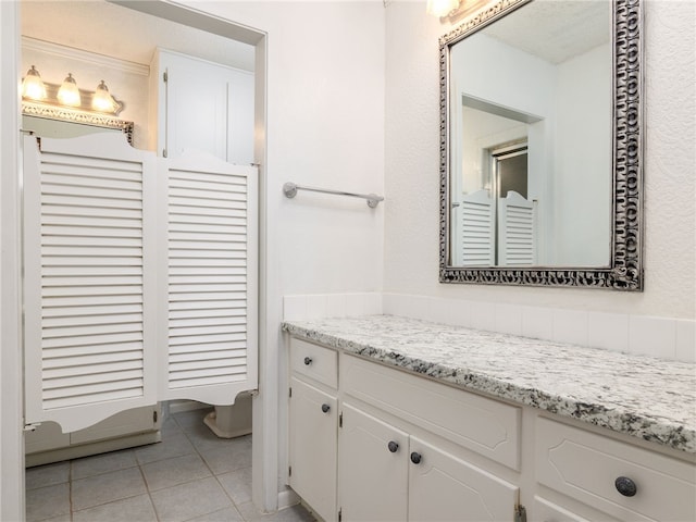 bathroom featuring tile patterned flooring and vanity