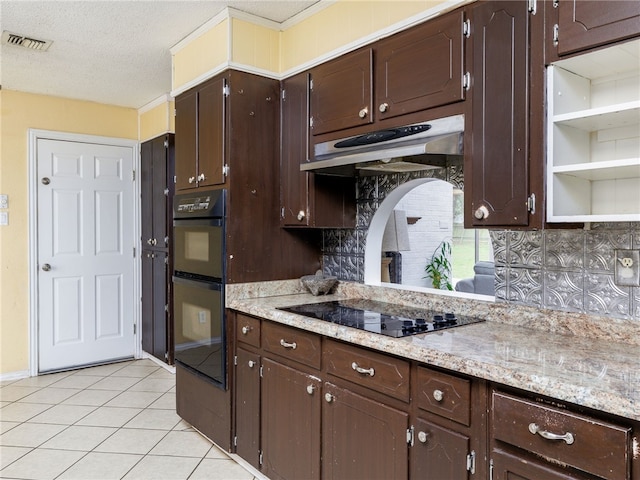 kitchen featuring dark brown cabinetry, a textured ceiling, decorative backsplash, light tile patterned floors, and black appliances