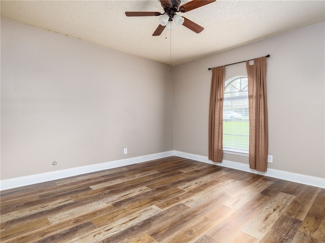 empty room featuring hardwood / wood-style floors, ceiling fan, and a textured ceiling