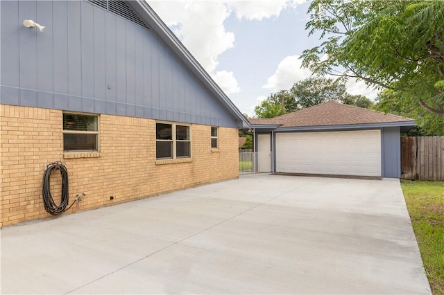 3614 Oak Ridge Dr, Bryan, TX 77802 - view of property exterior featuring a garage and brick siding