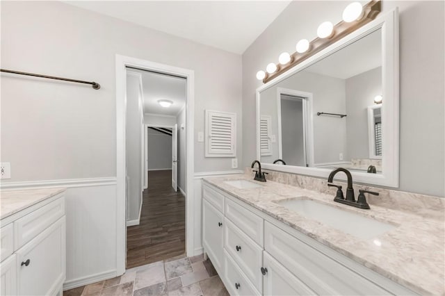3614 Oak Ridge Dr, Bryan, TX 77802 - bathroom featuring double vanity and baseboards