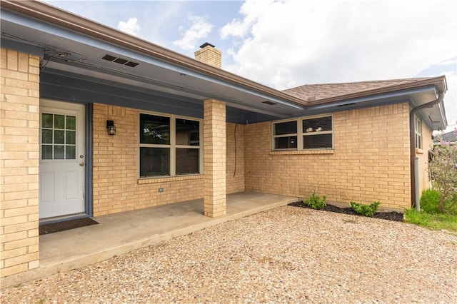 3614 Oak Ridge Dr, Bryan, TX 77802 - entrance to property featuring a chimney and brick siding