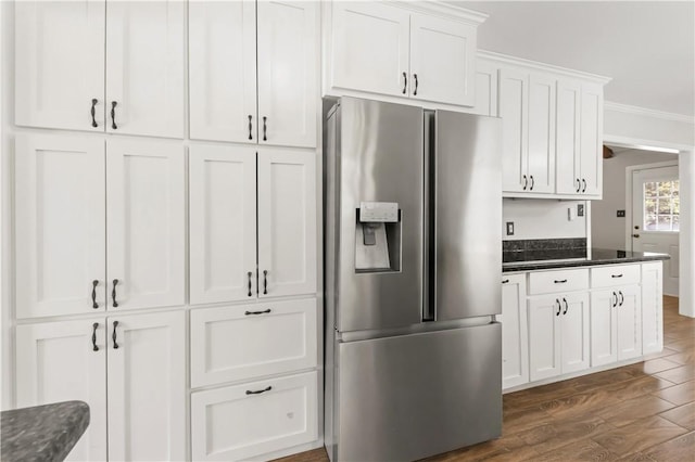 3614 Oak Ridge Dr, Bryan, TX 77802 - kitchen with stainless steel fridge with ice dispenser, dark wood finished floors, white cabinets, and dark stone countertops