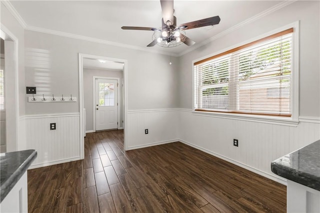 3614 Oak Ridge Dr, Bryan, TX 77802 - unfurnished dining area with a wainscoted wall, a ceiling fan, dark wood finished floors, and crown molding