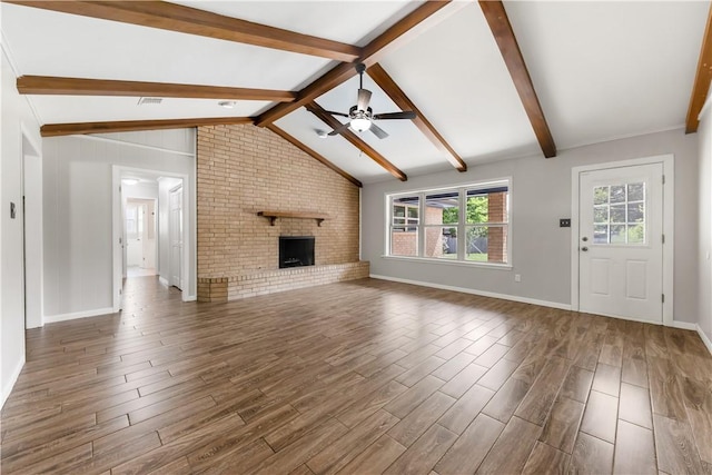 3614 Oak Ridge Dr, Bryan, TX 77802 - unfurnished living room with dark wood finished floors, ceiling fan, and a brick fireplace