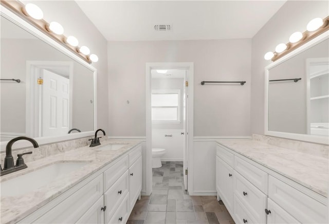 3614 Oak Ridge Dr, Bryan, TX 77802 - bathroom with double vanity and toilet