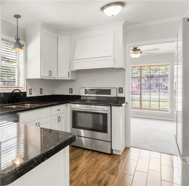 3614 Oak Ridge Dr, Bryan, TX 77802 - kitchen featuring stainless steel appliances, custom exhaust hood, crown molding, white cabinetry, and pendant lighting