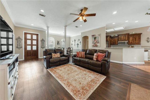 living room featuring visible vents, dark wood finished floors, ornamental molding, ornate columns, and recessed lighting