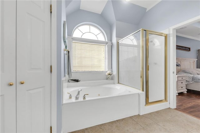 ensuite bathroom featuring a closet, vaulted ceiling, a shower stall, ensuite bath, and tile patterned flooring