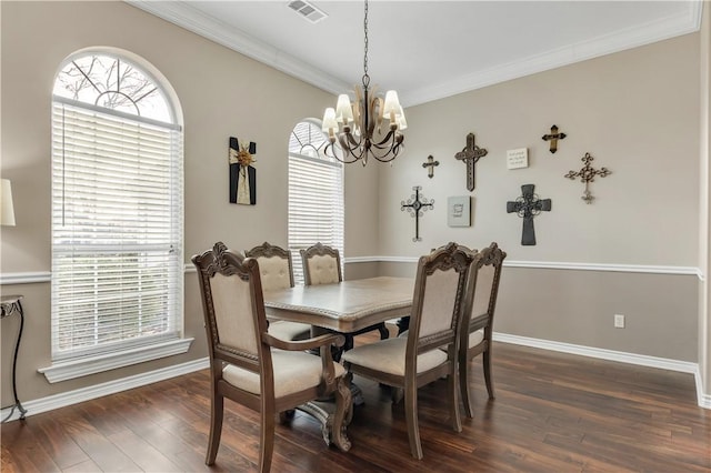 dining space with dark wood-style flooring, visible vents, crown molding, and a notable chandelier