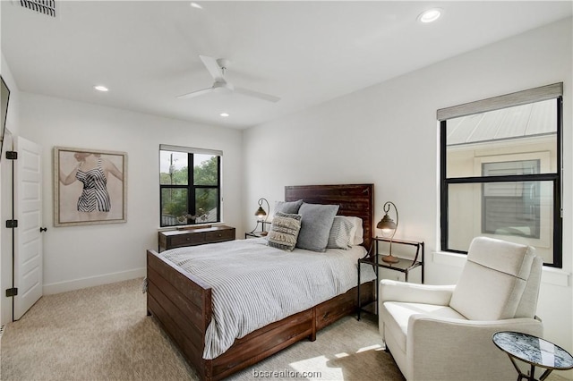 bedroom with ceiling fan and light carpet