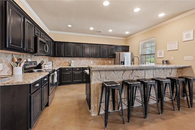 3015 Towers Pkwy, College Station, TX 77845 - kitchen featuring appliances with stainless steel finishes, a kitchen bar, light stone countertops, decorative backsplash, and recessed lighting