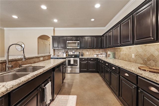 3015 Towers Pkwy, College Station, TX 77845 - kitchen featuring stainless steel appliances, arched walkways, concrete flooring, ornamental molding, and decorative backsplash