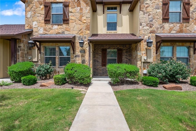 3015 Towers Pkwy, College Station, TX 77845 - view of exterior entry featuring stone siding and a yard