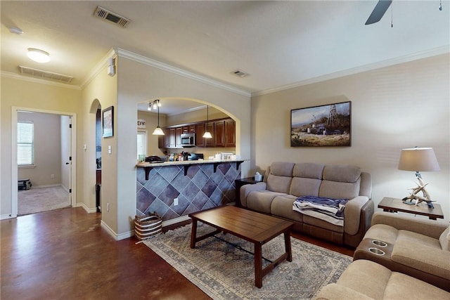 living room featuring ceiling fan and ornamental molding