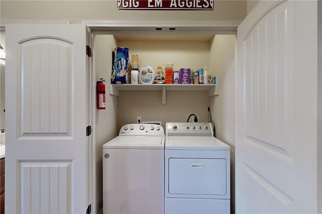 washroom with washing machine and clothes dryer