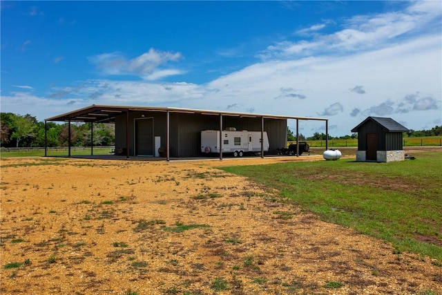 1981 County Road 202, Caldwell, TX 77836 - back of house with an outbuilding, a lawn, and board and batten siding