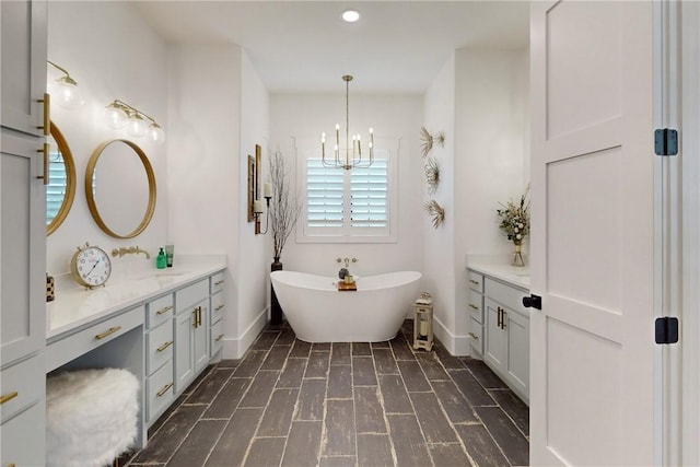 1981 County Road 202, Caldwell, TX 77836 - full bath with a chandelier, vanity, a freestanding tub, baseboards, and recessed lighting