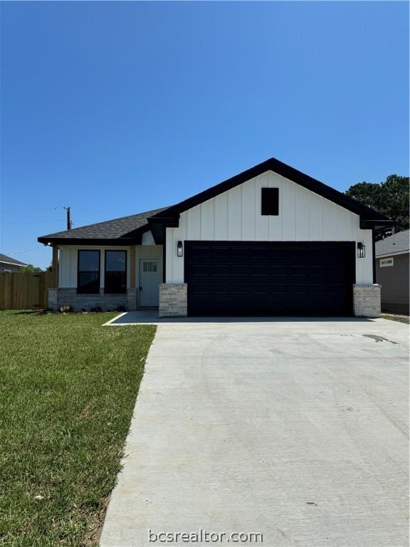 single story home with a garage and a front yard