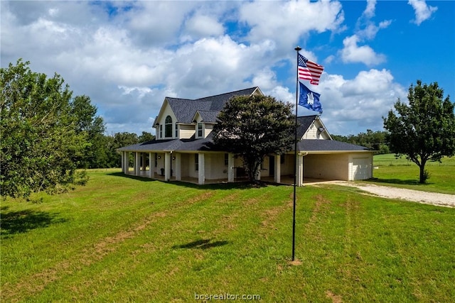 farmhouse featuring a front lawn and a garage