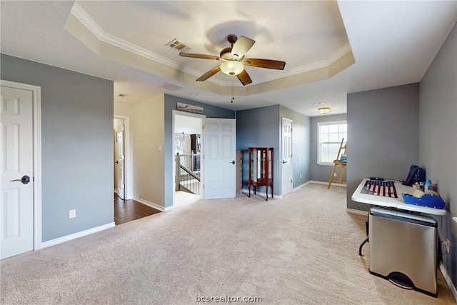 misc room featuring a raised ceiling, ceiling fan, carpet flooring, and crown molding