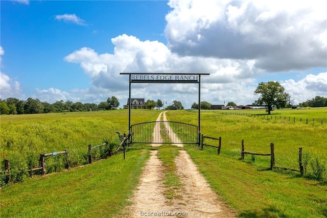 view of home's community featuring a yard and a rural view