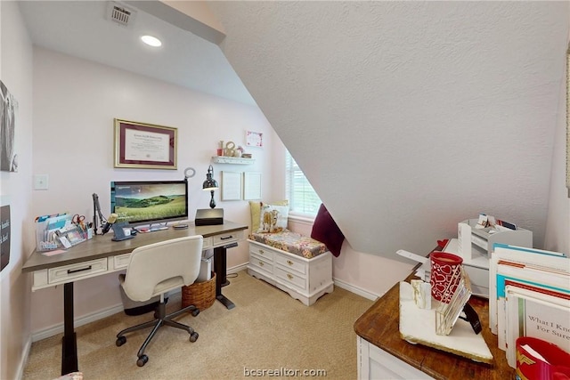 home office featuring light carpet and vaulted ceiling