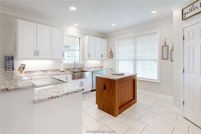 kitchen featuring dishwasher, white cabinets, sink, ornamental molding, and light stone counters