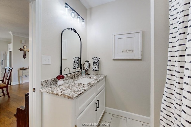 bathroom with tile patterned floors, vanity, and crown molding