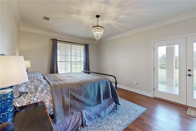 bedroom with access to outside, multiple windows, dark hardwood / wood-style flooring, and a chandelier