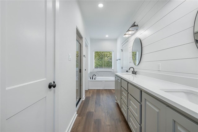 bathroom with vanity, hardwood / wood-style floors, and independent shower and bath