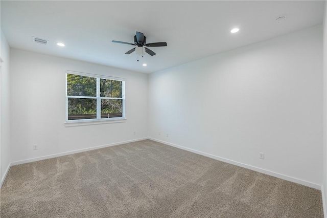 carpeted spare room with ceiling fan