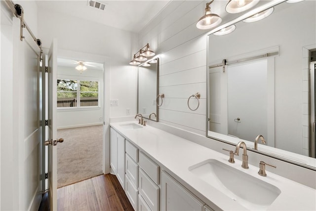 bathroom featuring hardwood / wood-style floors, vanity, and ceiling fan