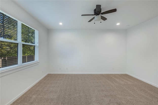 empty room with ceiling fan and carpet