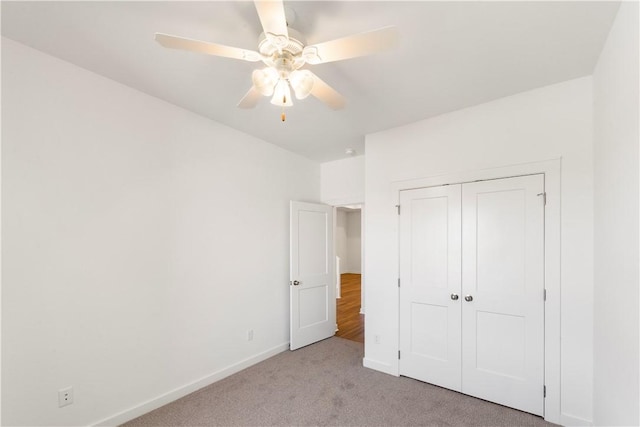 unfurnished bedroom featuring a closet, ceiling fan, and light colored carpet