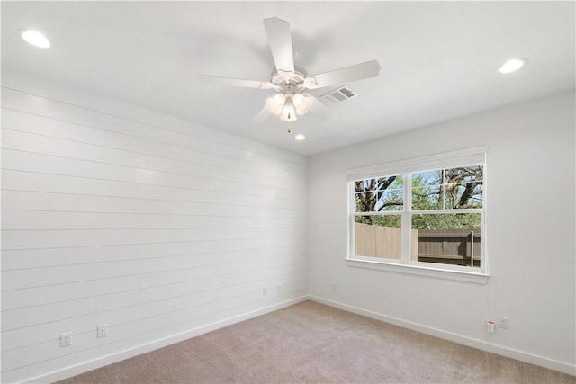 unfurnished room with light carpet and ceiling fan